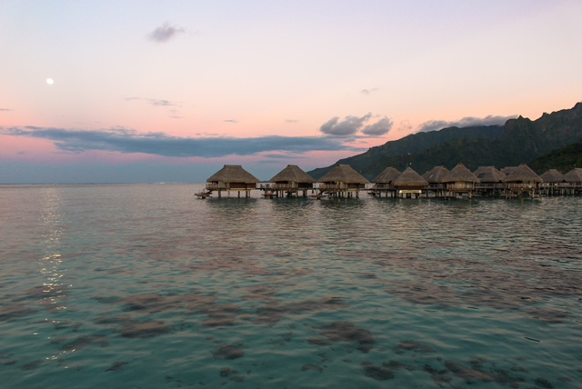 sunset over water bungalows