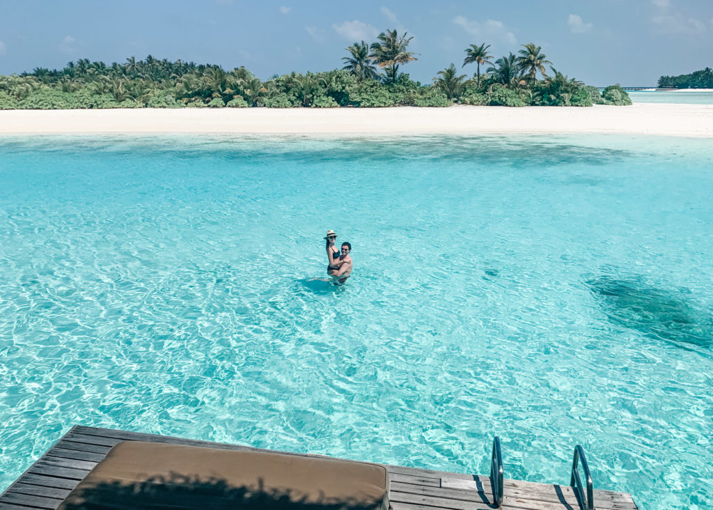 couple swimming in maldives lagoon