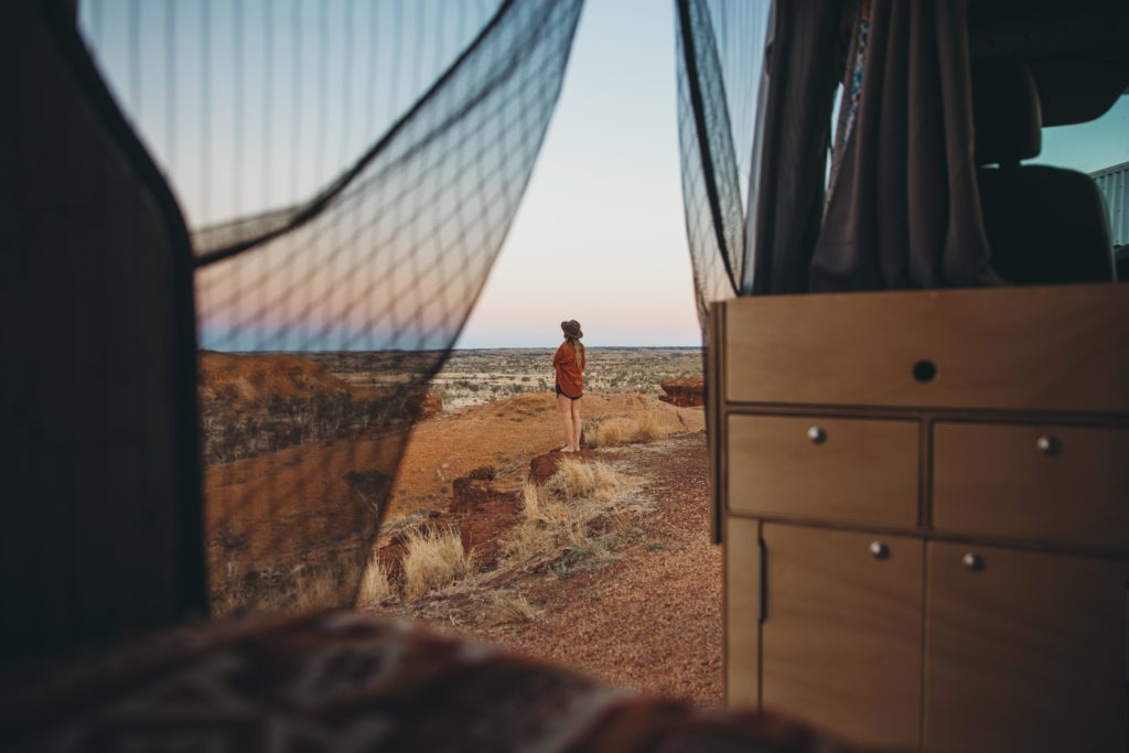 Woman camping outside of tent