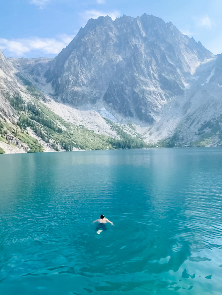 man swimming in colchuck lake