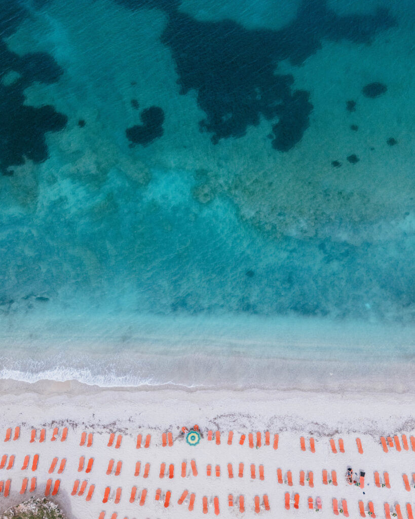 albania umbrellas beach blue water